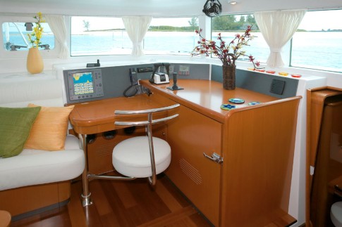 Inside Helm and Navigation Station: This shows the navigation station and the inside helm.  You steer the boat using a joy stick and it has a second set of throttles to control the two 55 hp Yanmar diesel engines.  Notice the freezer in the lower right side.  Leu Cat has two refrigerators and a freezer.